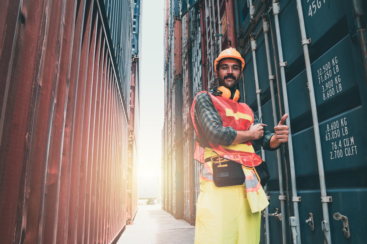 Worker engineer walking to checking the containers box from cargo ship for export and import