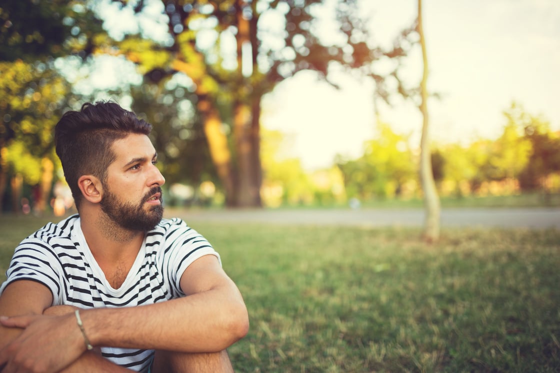 Young man overthinking in the park